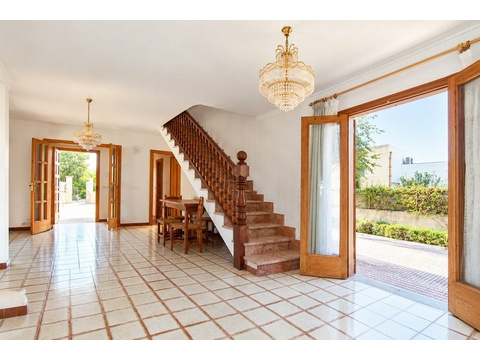 Repräsentativer Eingangsbereich mit eleganter Treppe und direktem Zugang zum Außenbereich