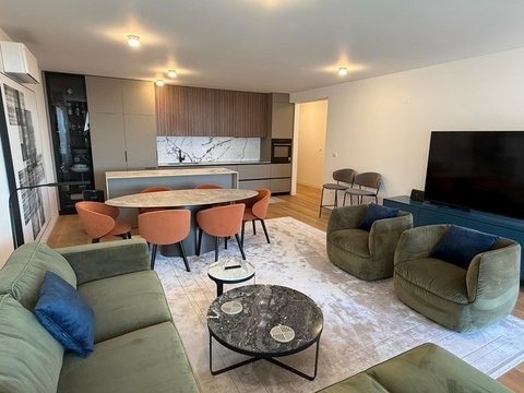 Sofa, Couchtisch und Fernseher im Wohnzimmer