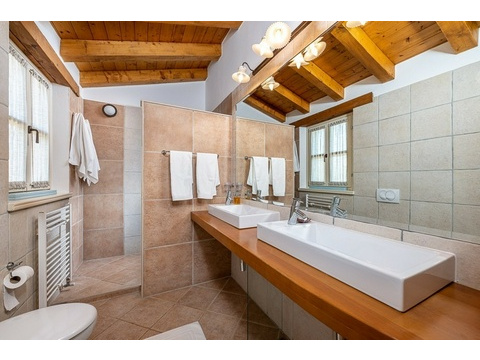 Badezimmer mit Spiegel, Fenster und Dusche