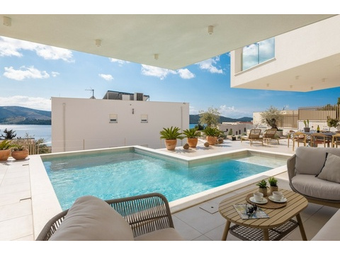 Überdachte Terrasse mit Blick auf Pool und Meer